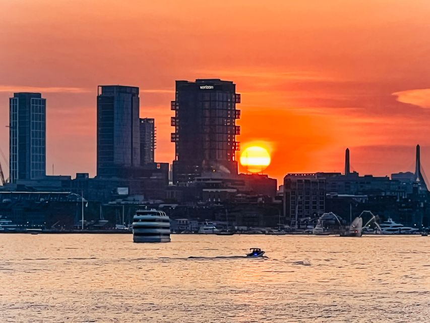 Boston: Boston Harbor Sunset Cruise - Outdoor seating, indoor shelter, and the boat itself